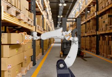 Robotic Arm Taking A Cardboard Box In The Warehouse